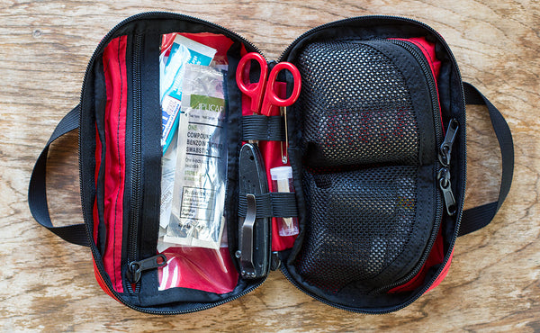 Interior shot of a filled First Aid Pouch in Red